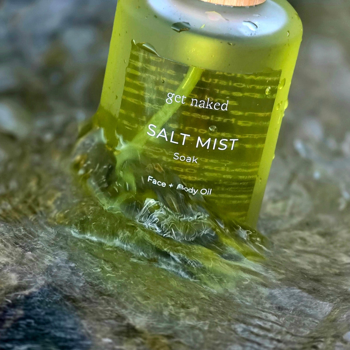 Get Naked Salt Mist Australian face and body oil standing in flowing coastal water